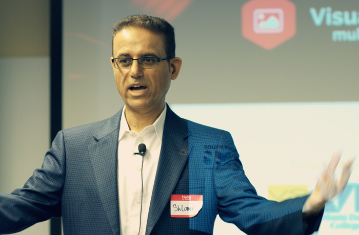 Shlomi Ron speaking on stage