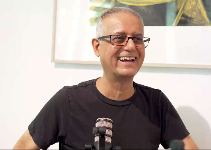 Shlomi Ron laughing at the microphone